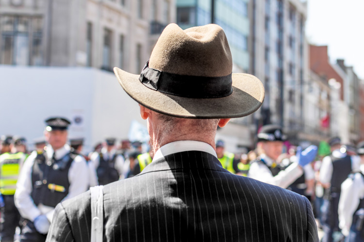 Climate change protestors smartly dressed watching police
