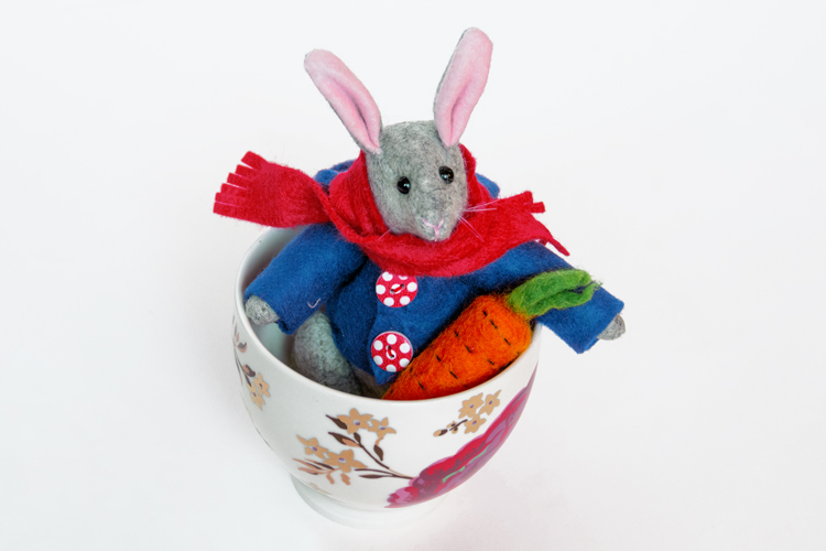 Felt rabbit in a cup with a carrot