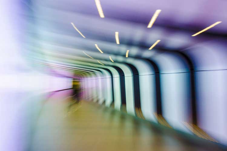 Motion blur through illuminous tunnel in King's Cross